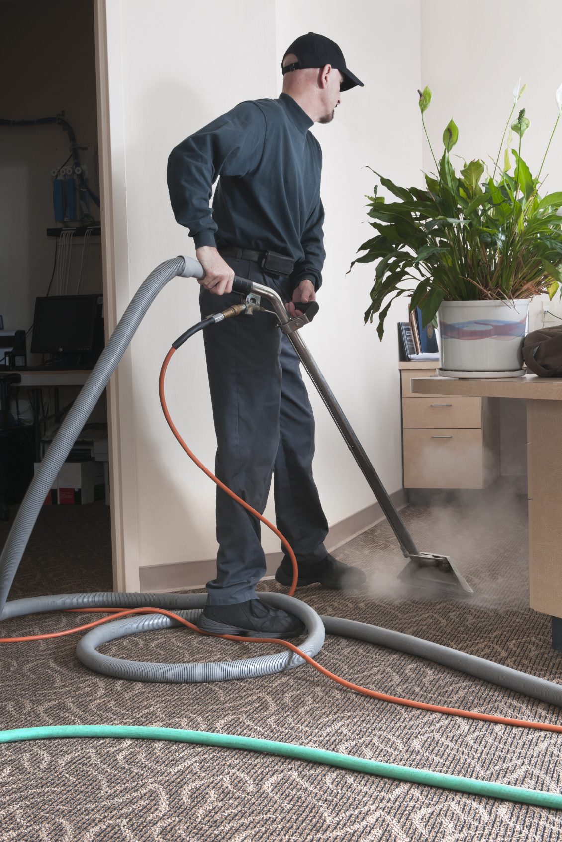carpet cleaning local A person using a carpet cleaner in an indoor setting.